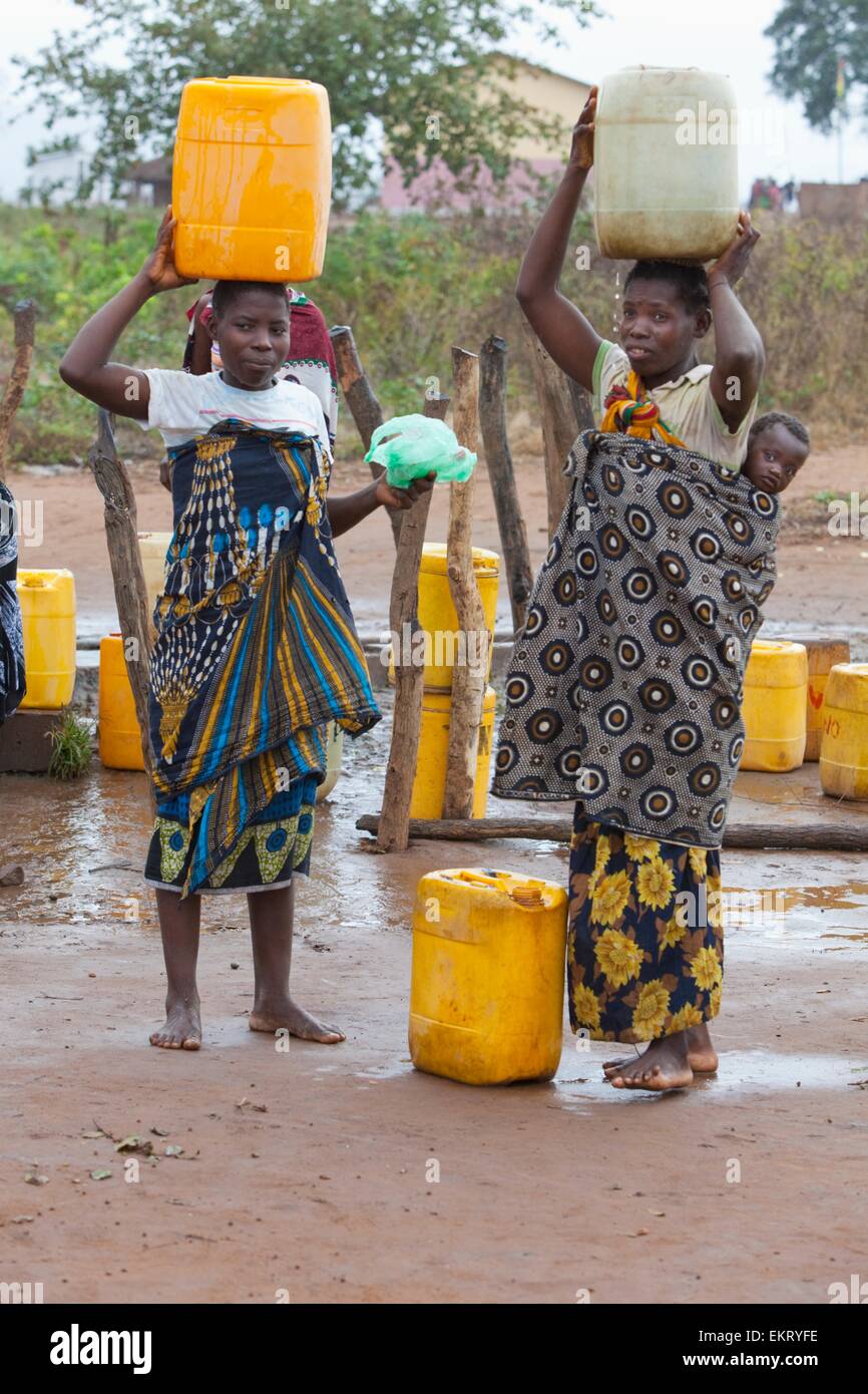 Two Women Carry Large Water Jugs On Their Heads Manica Mozambique two-women-carry-large-water-jugs-on-their-heads-manica-mozambique