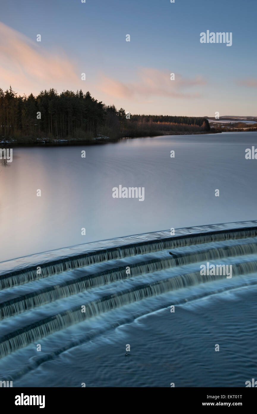 Winter sunset at Fewston Reservoir, with the overflow in the foreground. Stock Photo