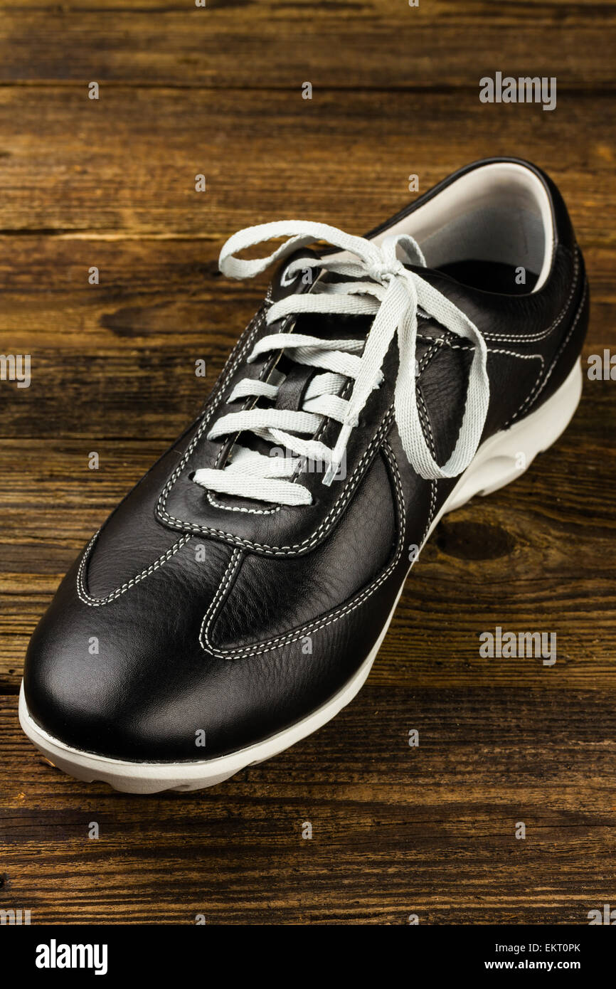 black leather man's shoe on wooden background Stock Photo - Alamy