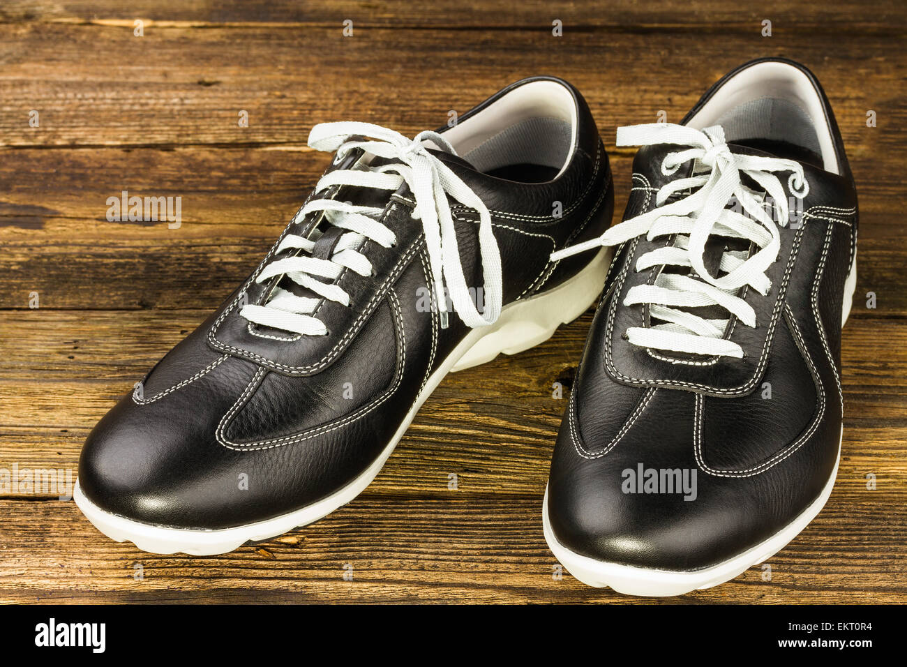 black leather man's shoe on wooden background Stock Photo - Alamy