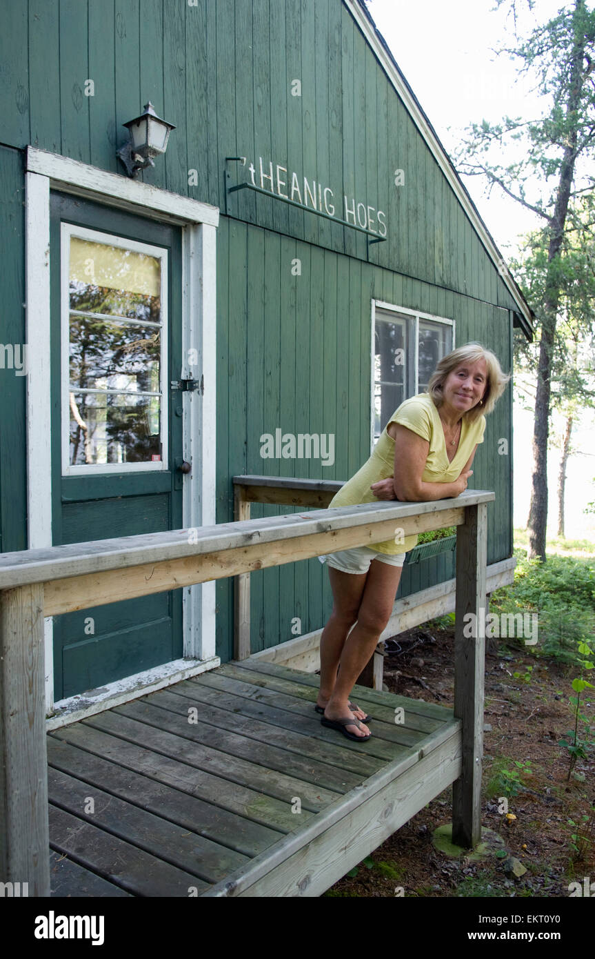 Woman Standing On Her Cabin Porch Stock Photo - Alamy