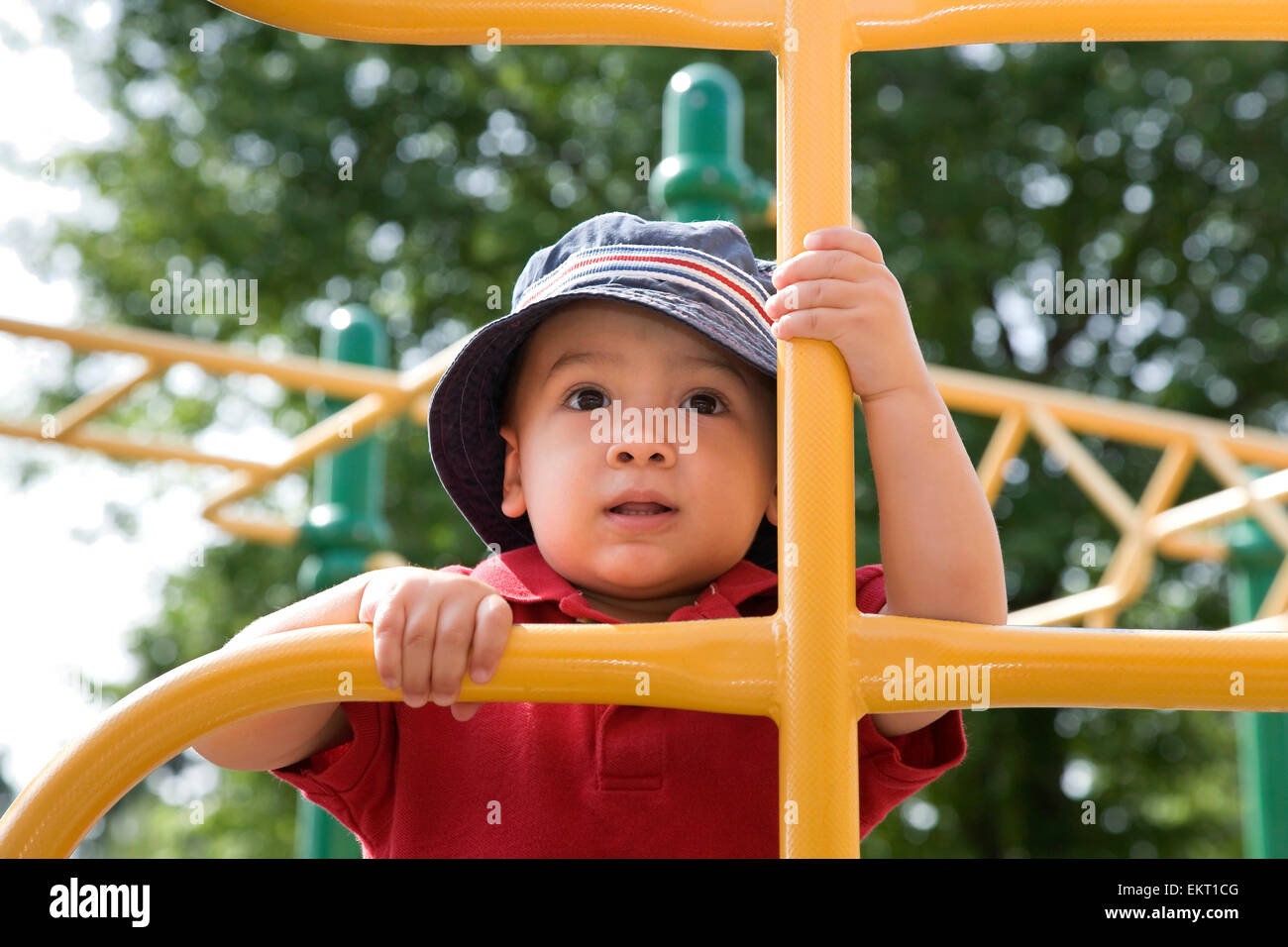 Young AsianCaucasian Boy Climbing Playground Equipment; Ontario Canada