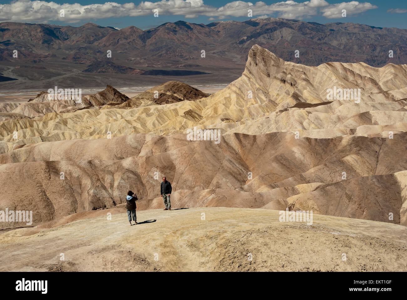Hiker Taking A Photo In The Badlands Of Zabriskie Point In Death Valley ...