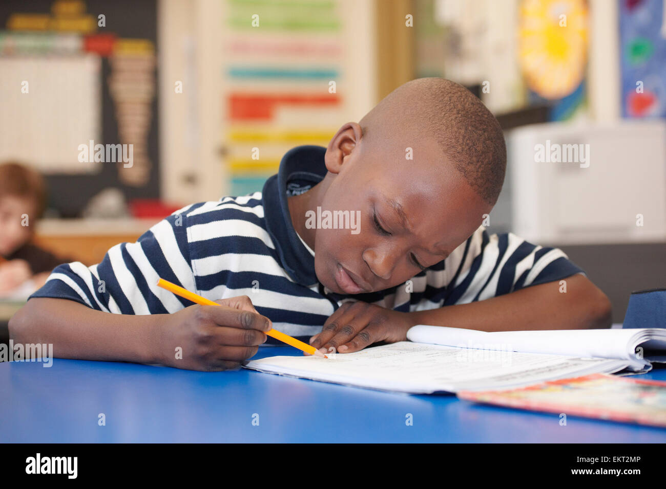 Young Boy In Grade 3 Working At His Desk In Classroom, Toronto, Ontario, Canada Stock Photo