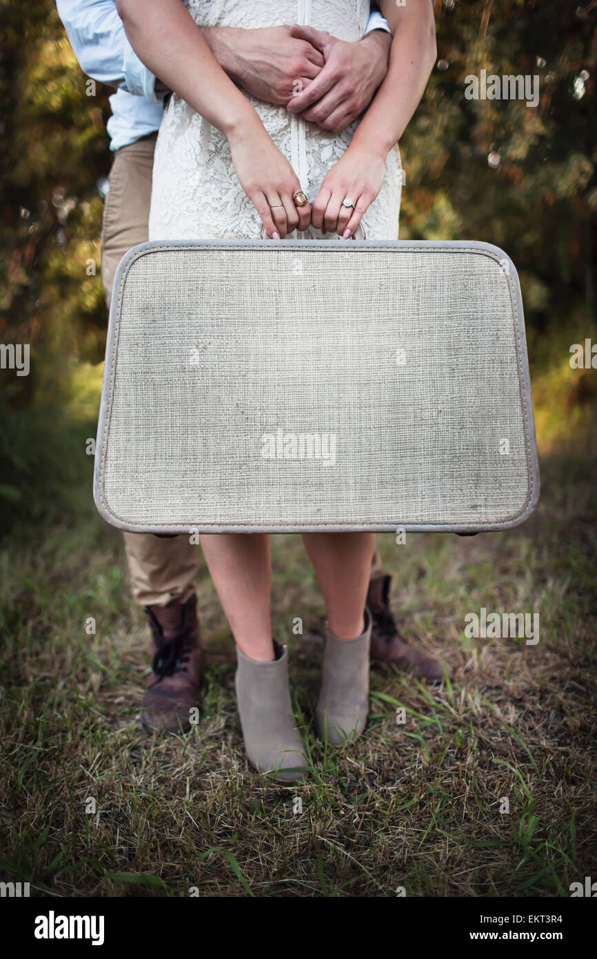 A couple holding a vintage suitcase; Edmonton, Alberta, Canada Stock