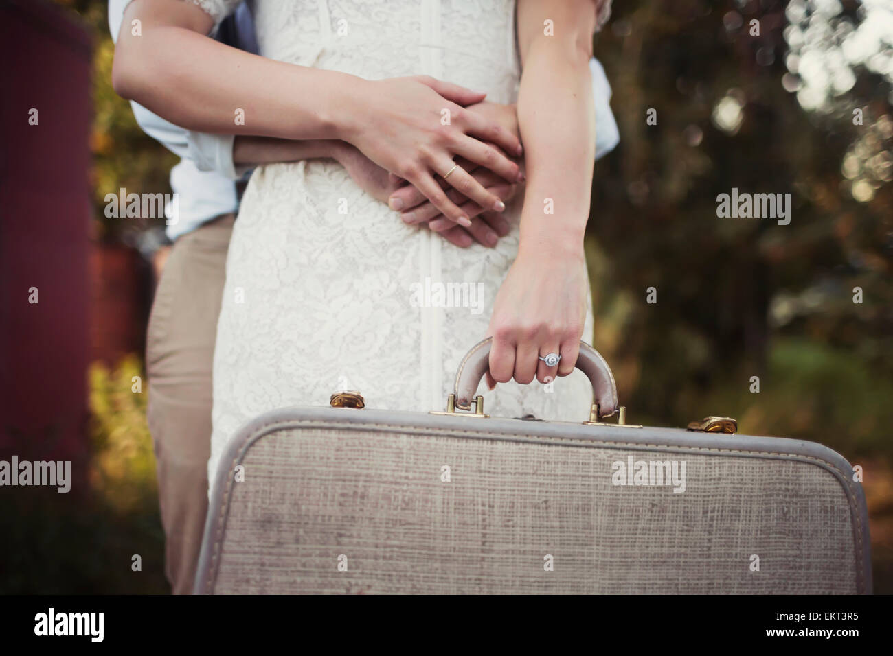 A couple holding a vintage suitcase; Edmonton, Alberta, Canada Stock