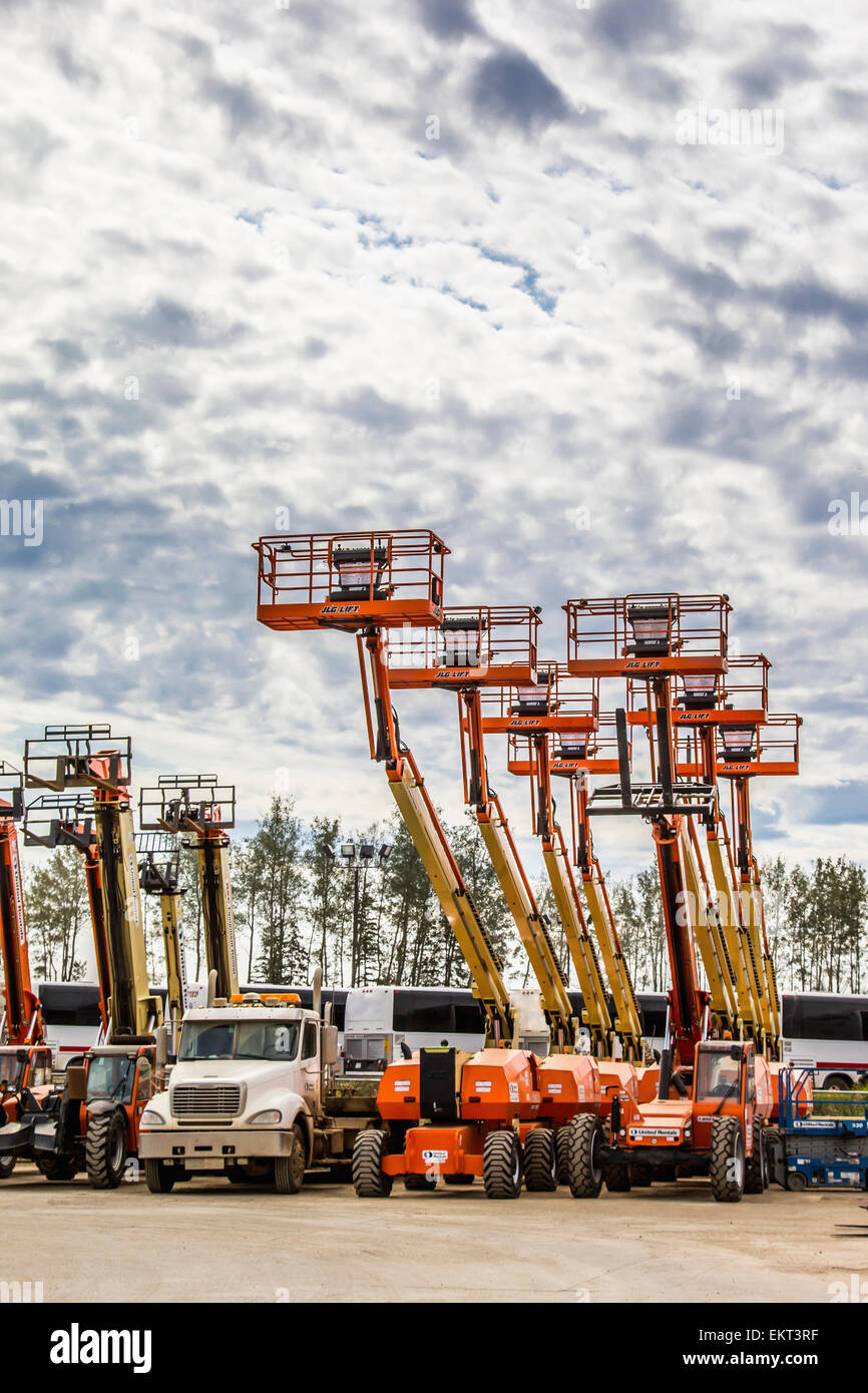 A storage yard full of man lifts used for construction work; Fort