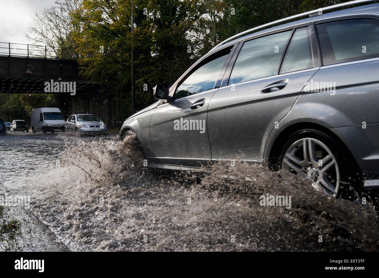 A car splashes through flood water on the road; United Kingdom Stock Photo Alamy