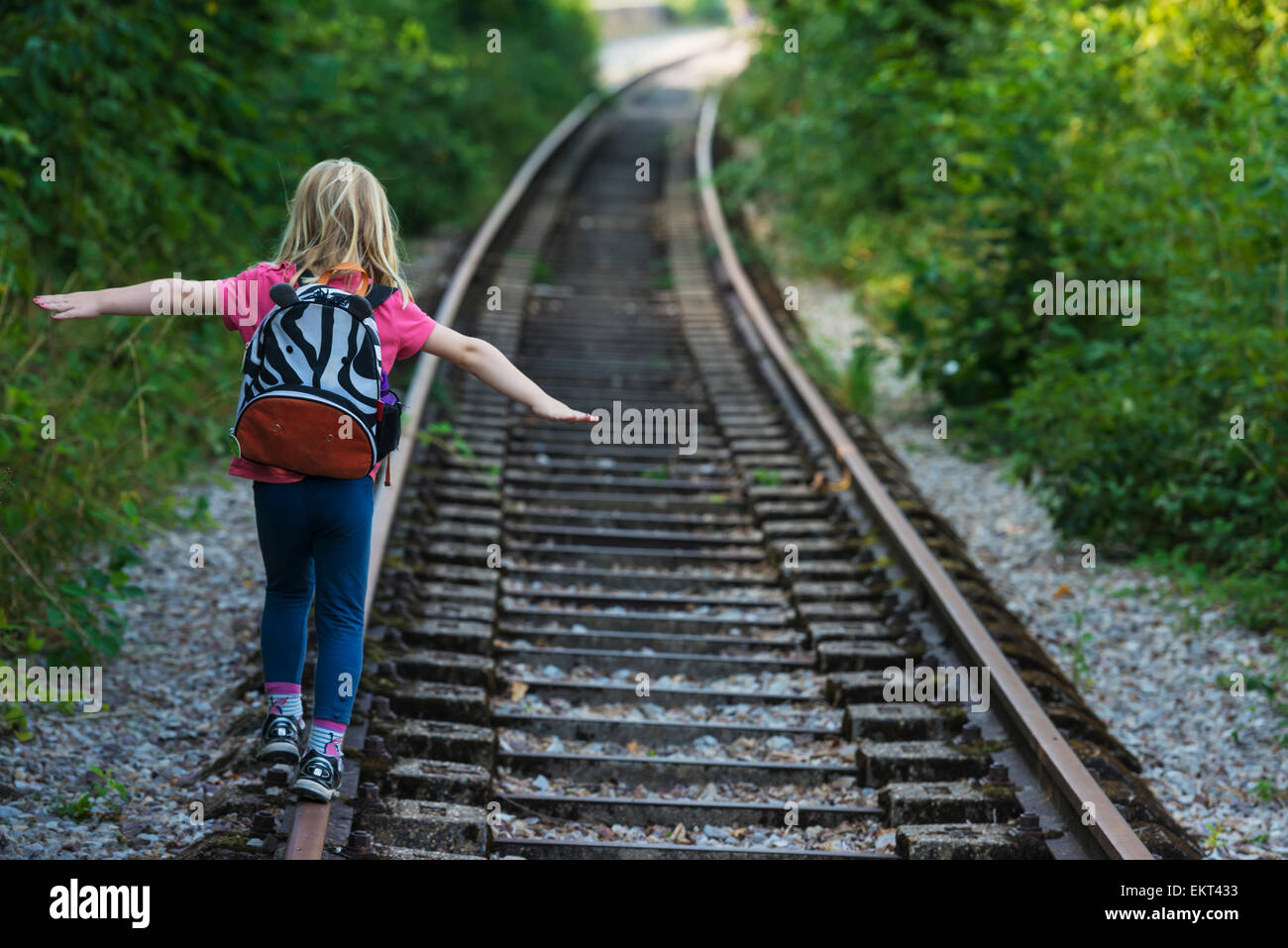 Girl walking along abandoned railway track, near Clecy; Normandy ...