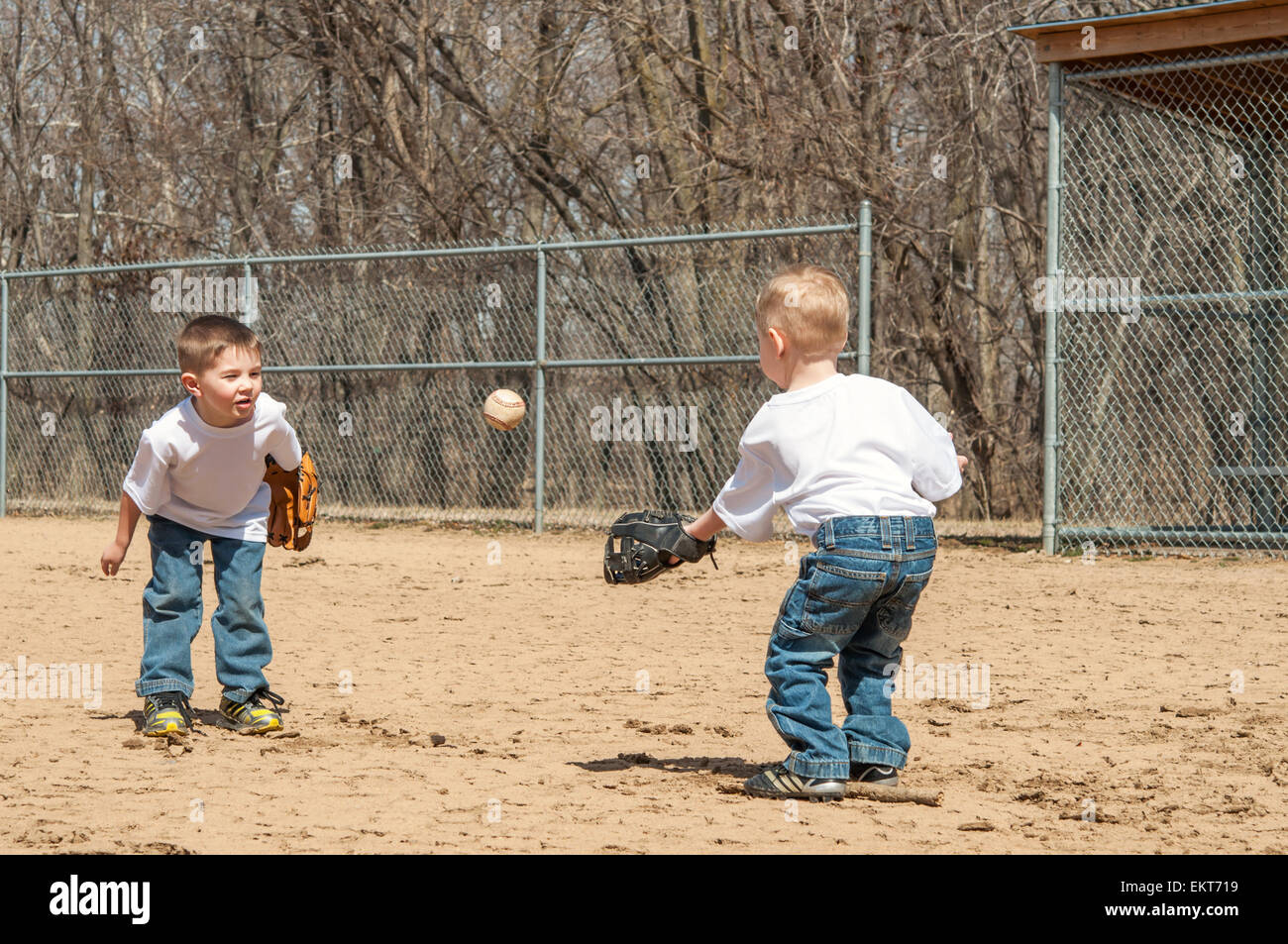Two boys play catch throwing ball Stock Photo