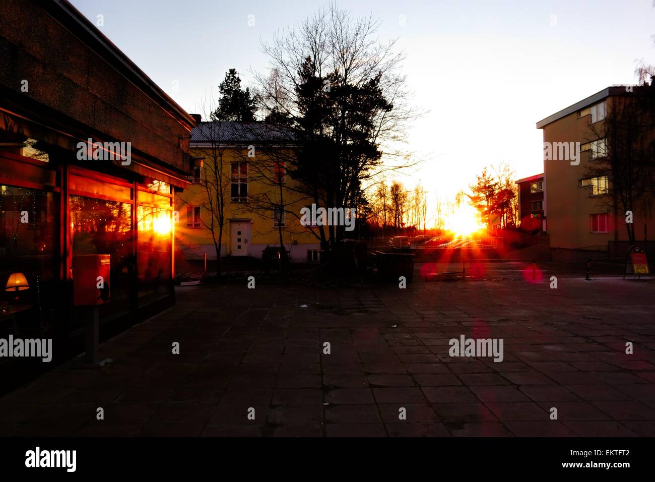 Two suns setting in an urban landscape. Stock Photo