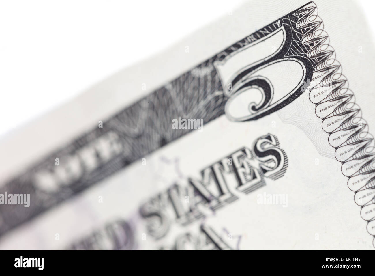 Part of five dollar bill macro on white background, shallow depth of field Stock Photo