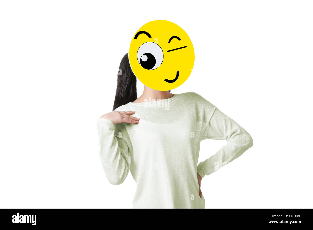 Young woman with a winking emoticon face in front of her face Stock Photo