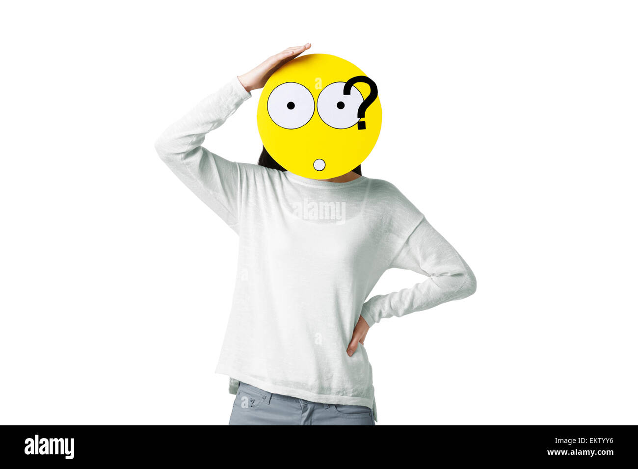 Young woman with a confused emoticon face in front of her face Stock Photo