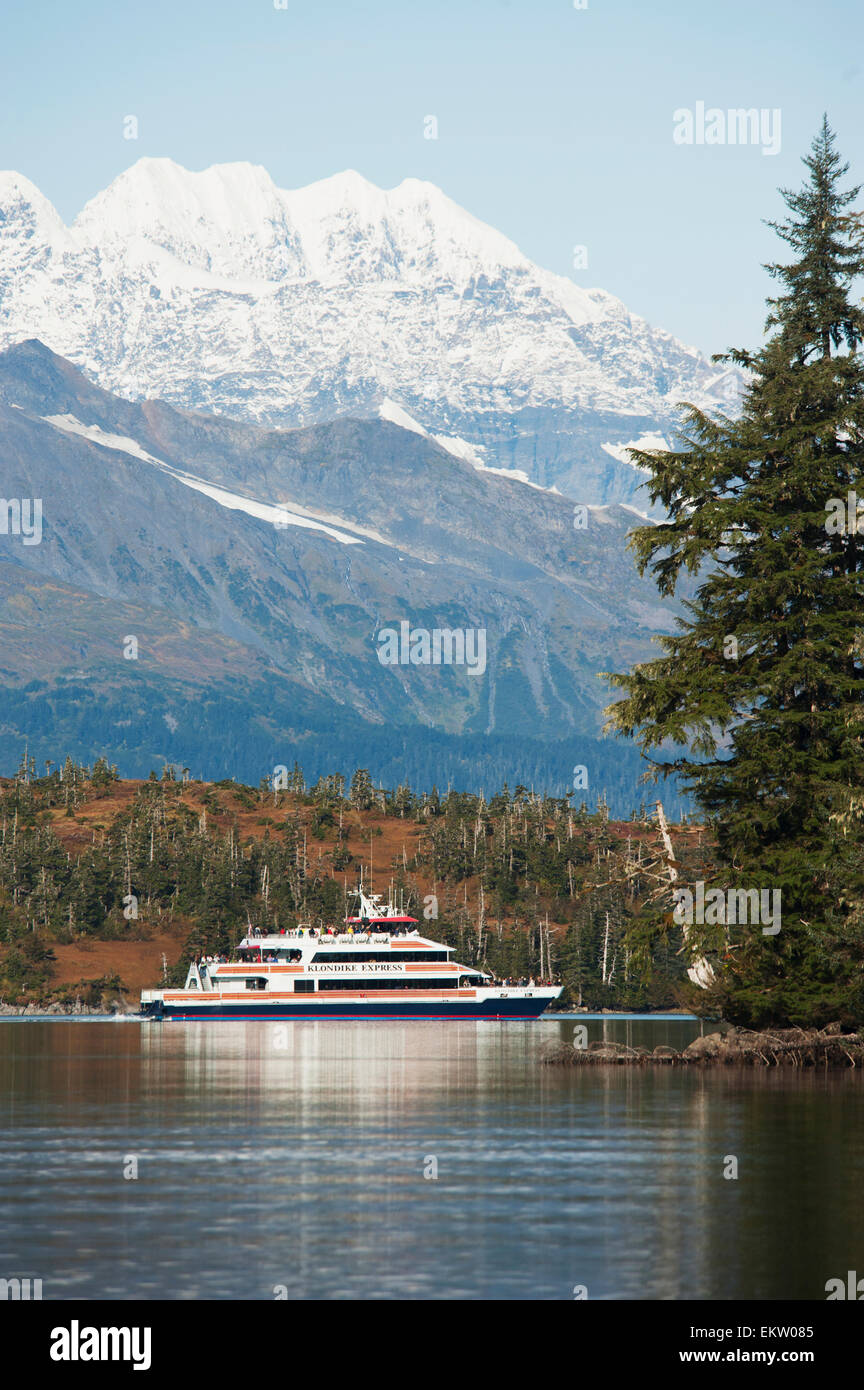 Tourists cruise by Esther Island on the Klondike Express sightseeing