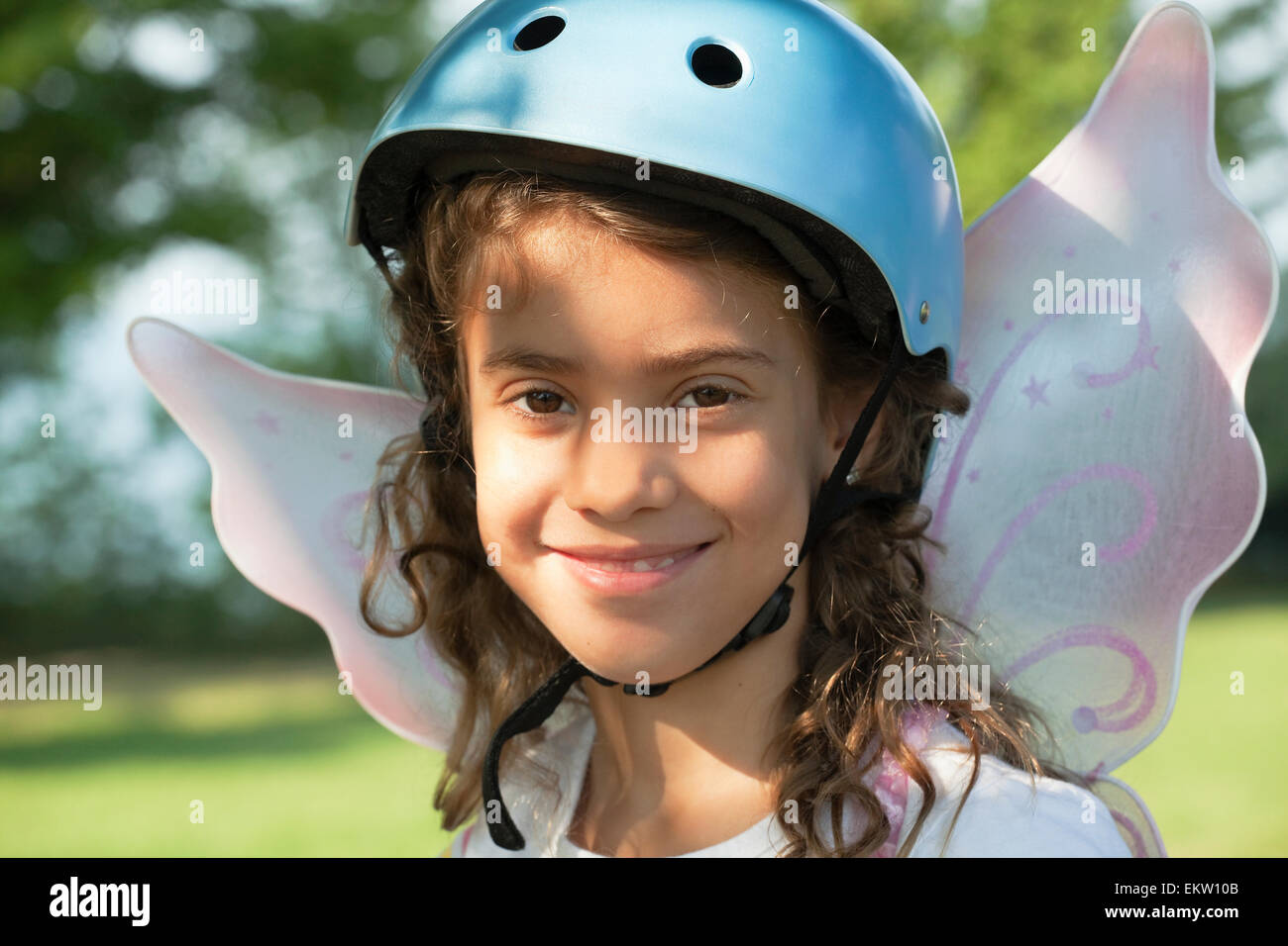 Portrait Of Young Girl Wearing A Bike Helmet And Fairy Wings;Whitby