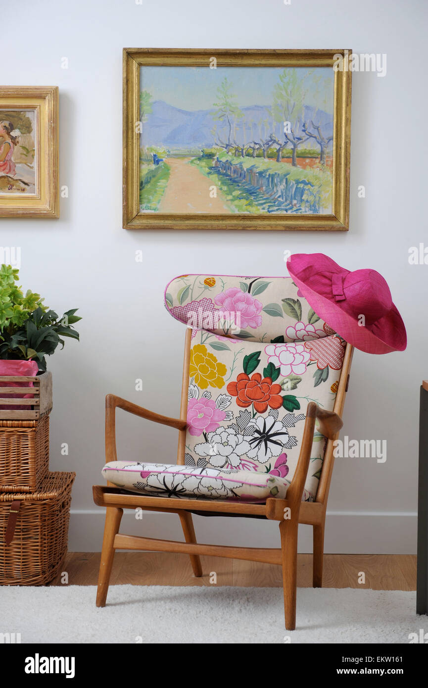 Ladies pink straw hat on an easy chair UK Stock Photo