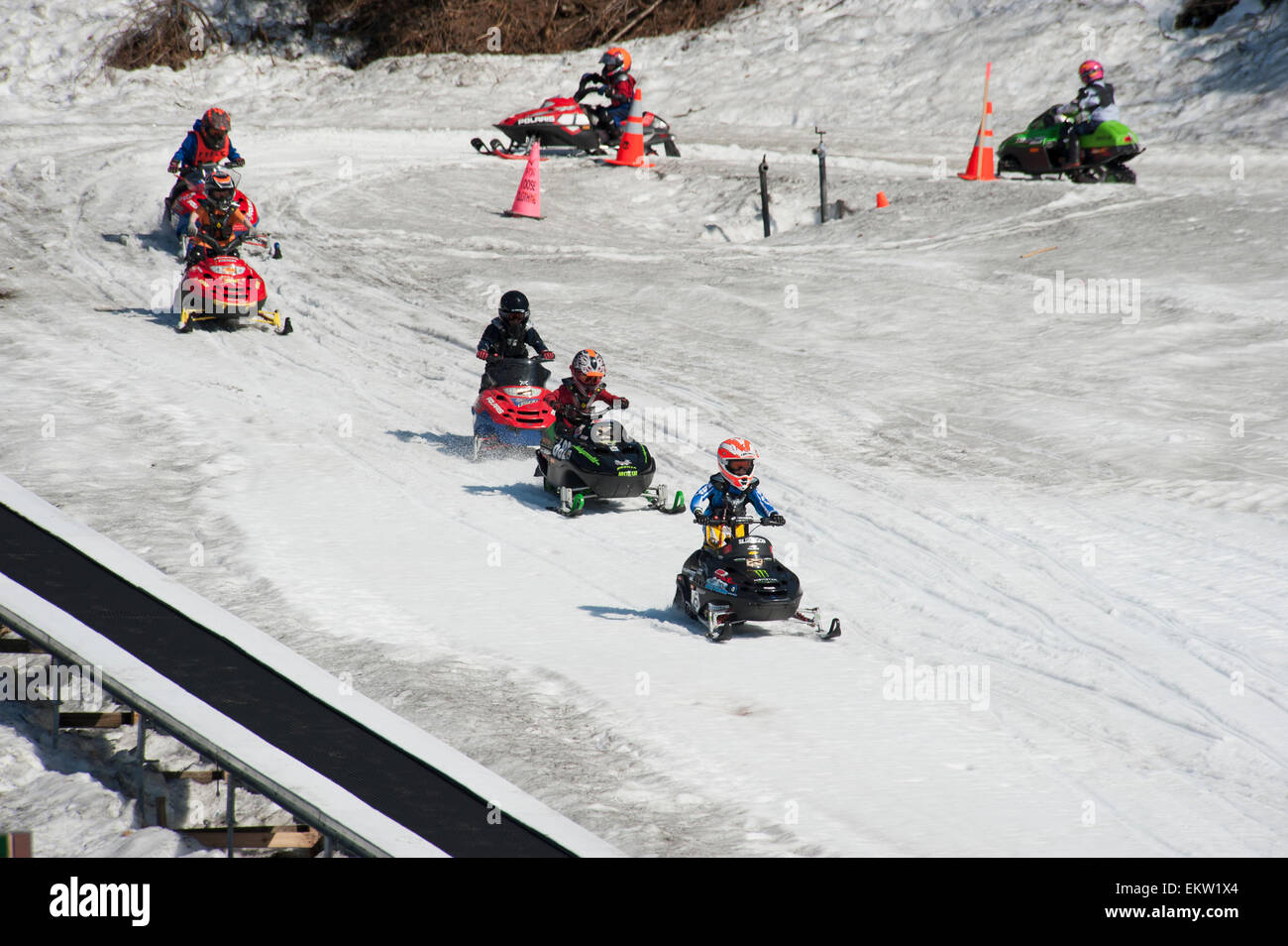 Kids racing snow machines at Alyeska Resort in Girdwood, Alaska Stock