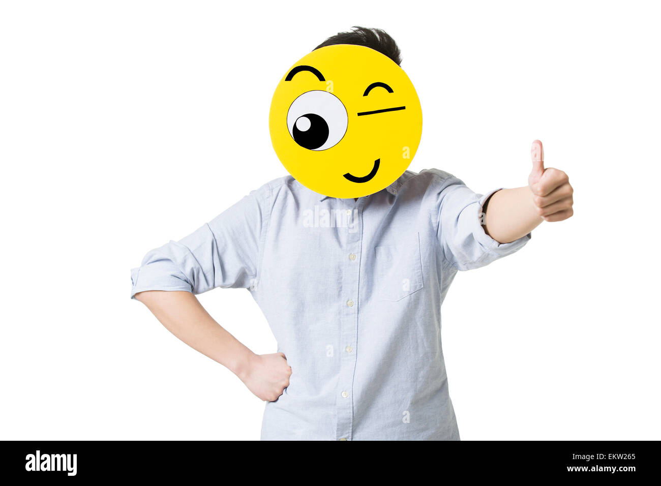 Young man giving thumbs up with a winking emoticon face in front of his face  Stock Photo - Alamy, image size:1300x956
