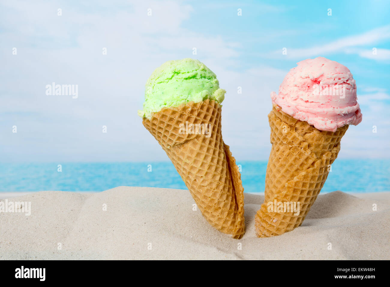 Funny image of two ice cream cones in the beach sand Stock Photo