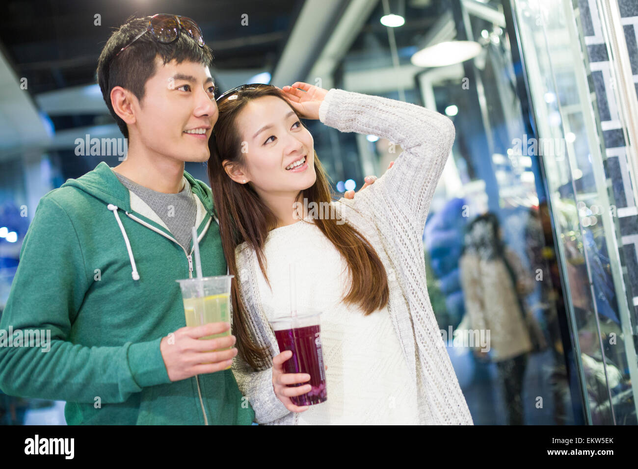 Young couple walking in shopping mall Stock Photo