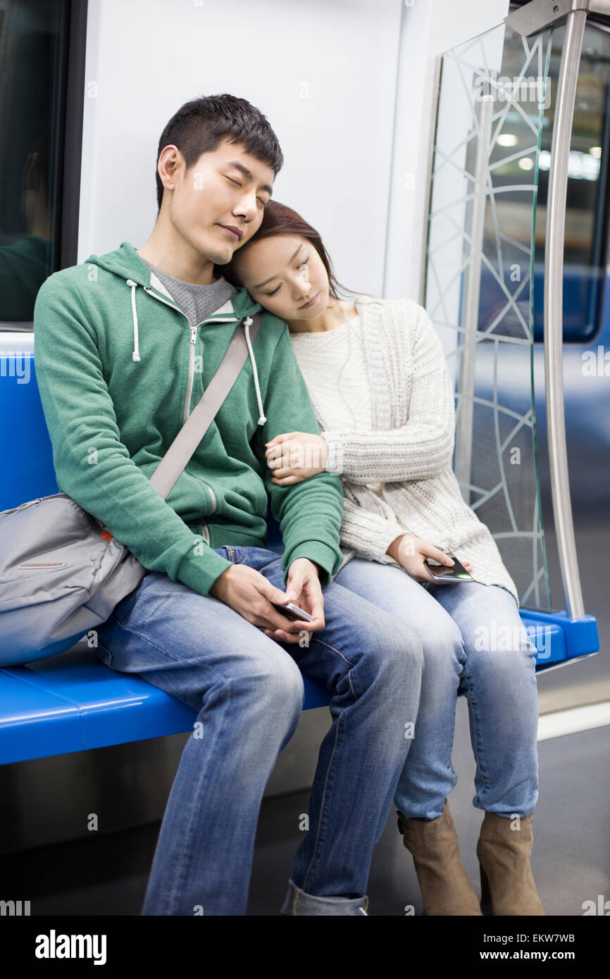 Tired couple sitting in subway Stock Photo