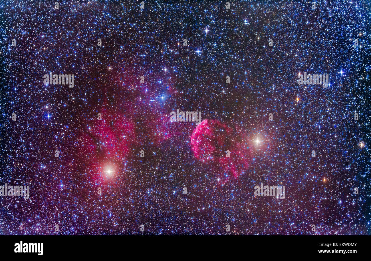 The supernova remnant IC 443 in Gemini near the stars Mu Geminorum (left) and Eta Geminorum (right. Slight haze passing thru on Stock Photo