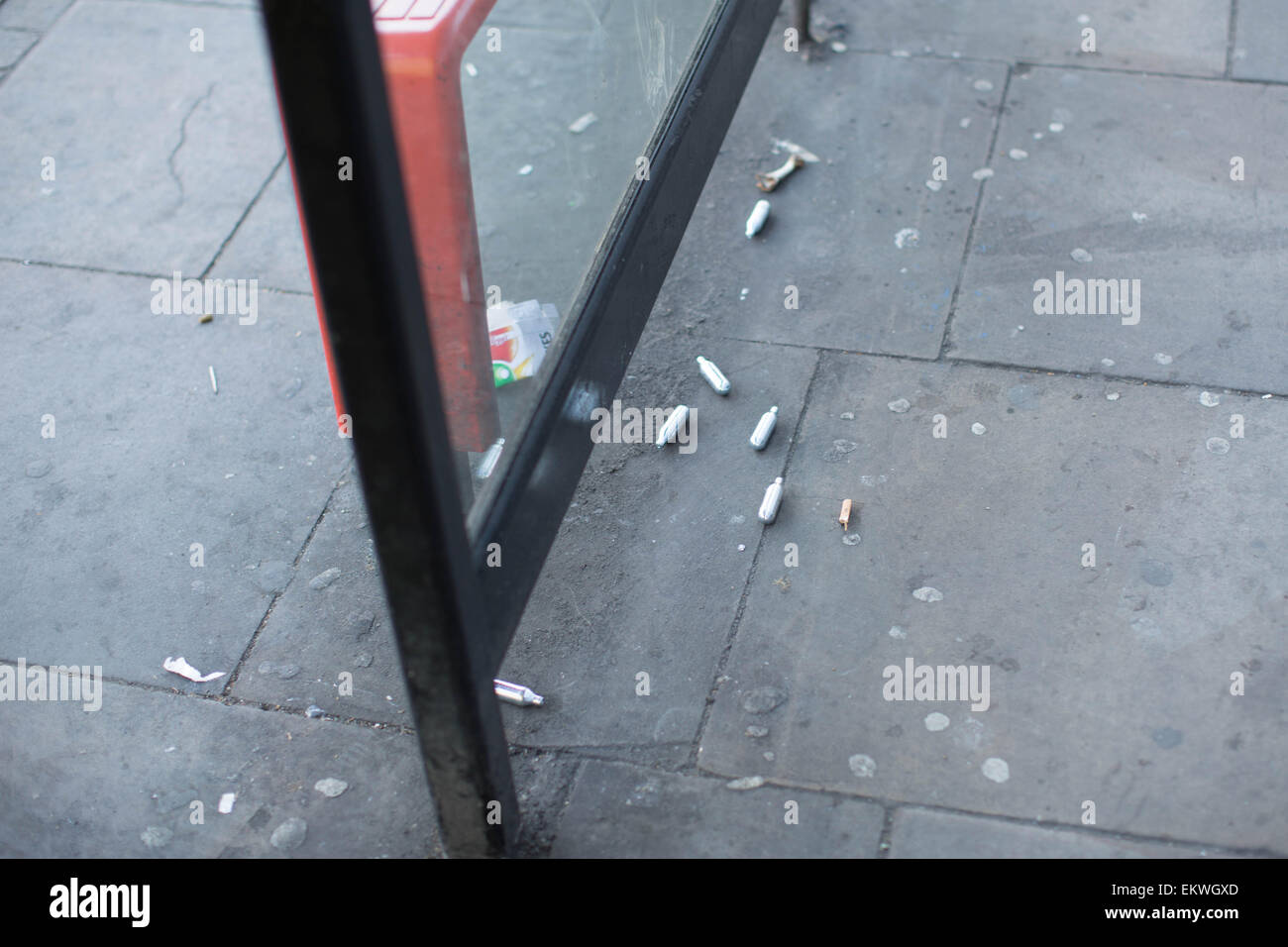 Shoreditch, London, UK 14th April 2015. Nitrous Oxide canisters litter a bus stop. Evidence of