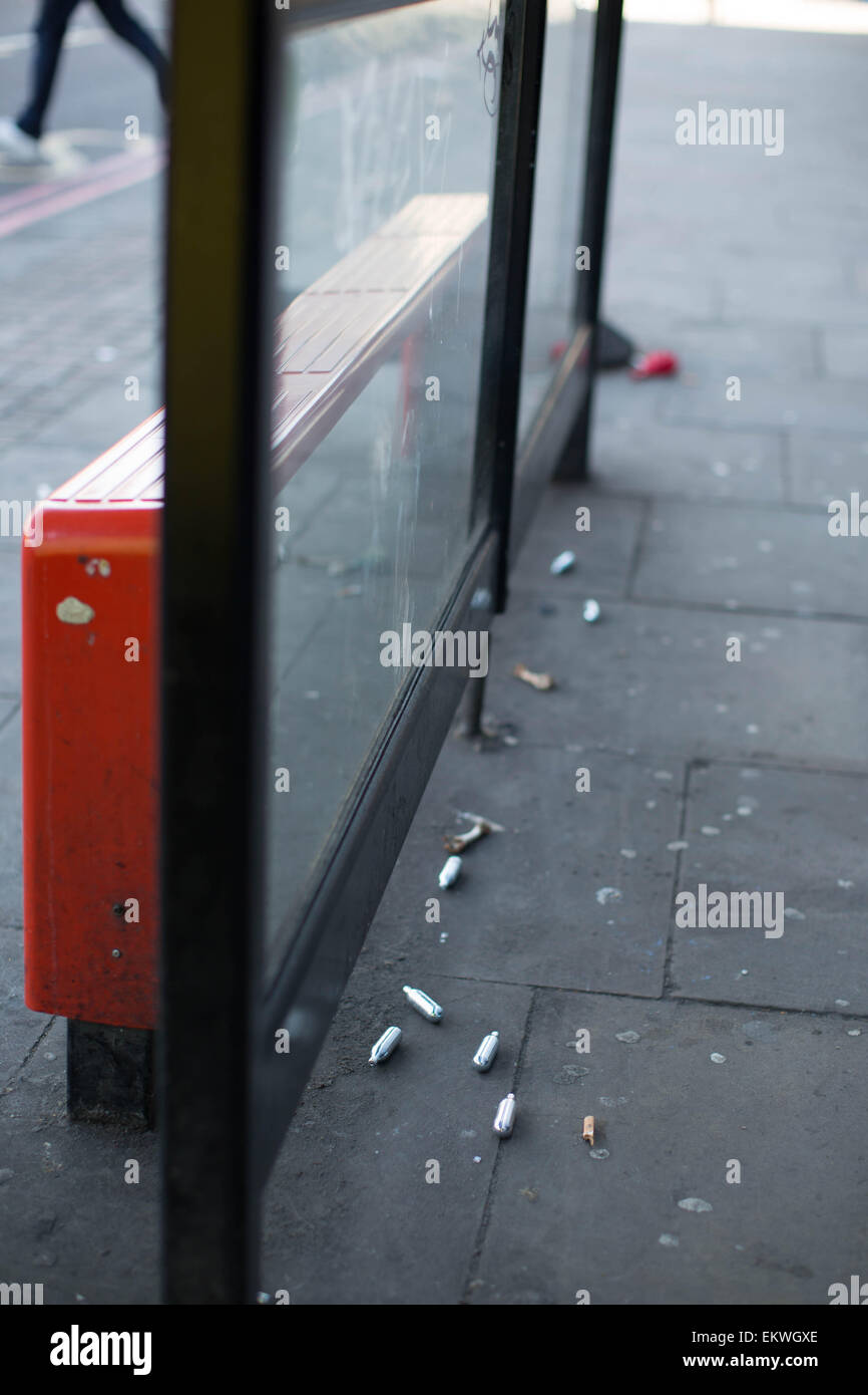 Shoreditch, London, UK 14th April 2015. Nitrous Oxide canisters litter a bus stop. Evidence of