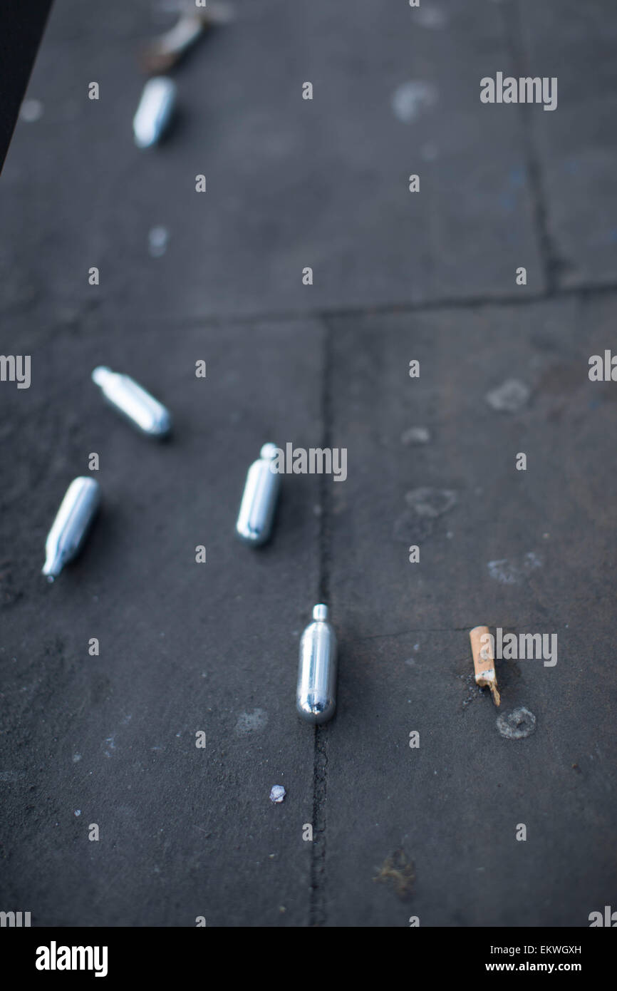 Shoreditch, London, UK 14th April 2015. Nitrous Oxide canisters litter a bus stop. Evidence of