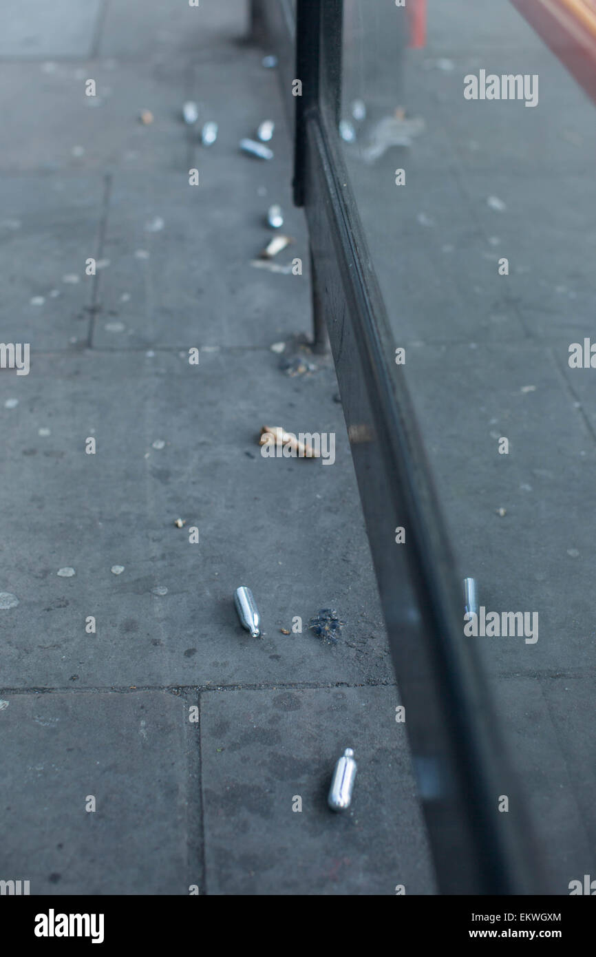 Shoreditch, London, UK 14th April 2015. Nitrous Oxide canisters litter a bus stop. Evidence of