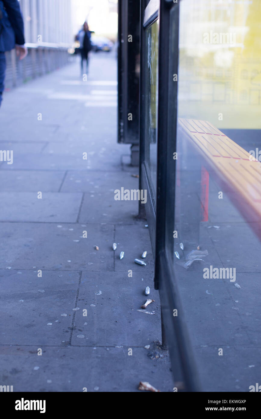 Shoreditch, London, UK 14th April 2015. Nitrous Oxide canisters litter a bus stop. Evidence of