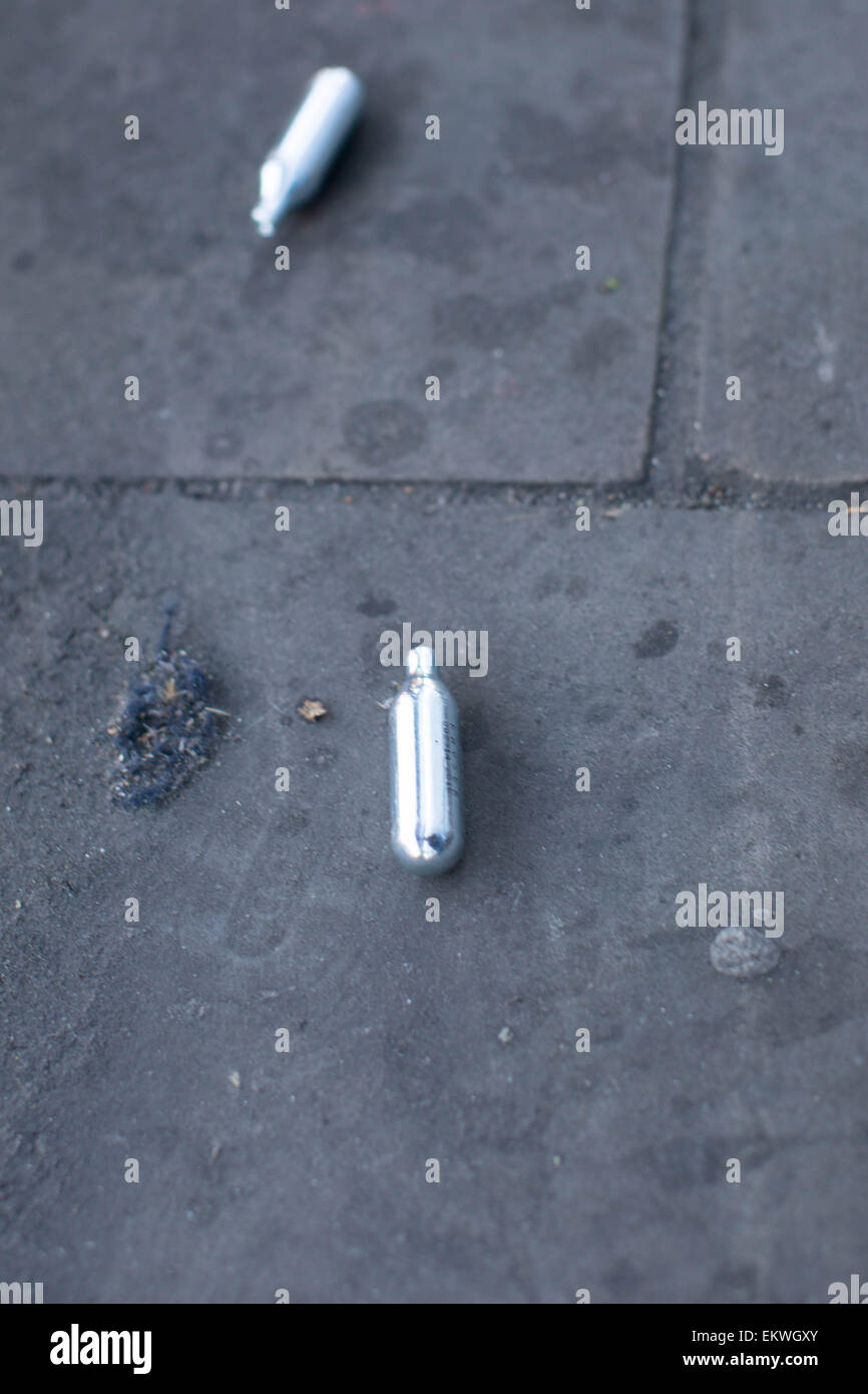Shoreditch, London, UK 14th April 2015. Nitrous Oxide canisters litter a bus stop. Evidence of