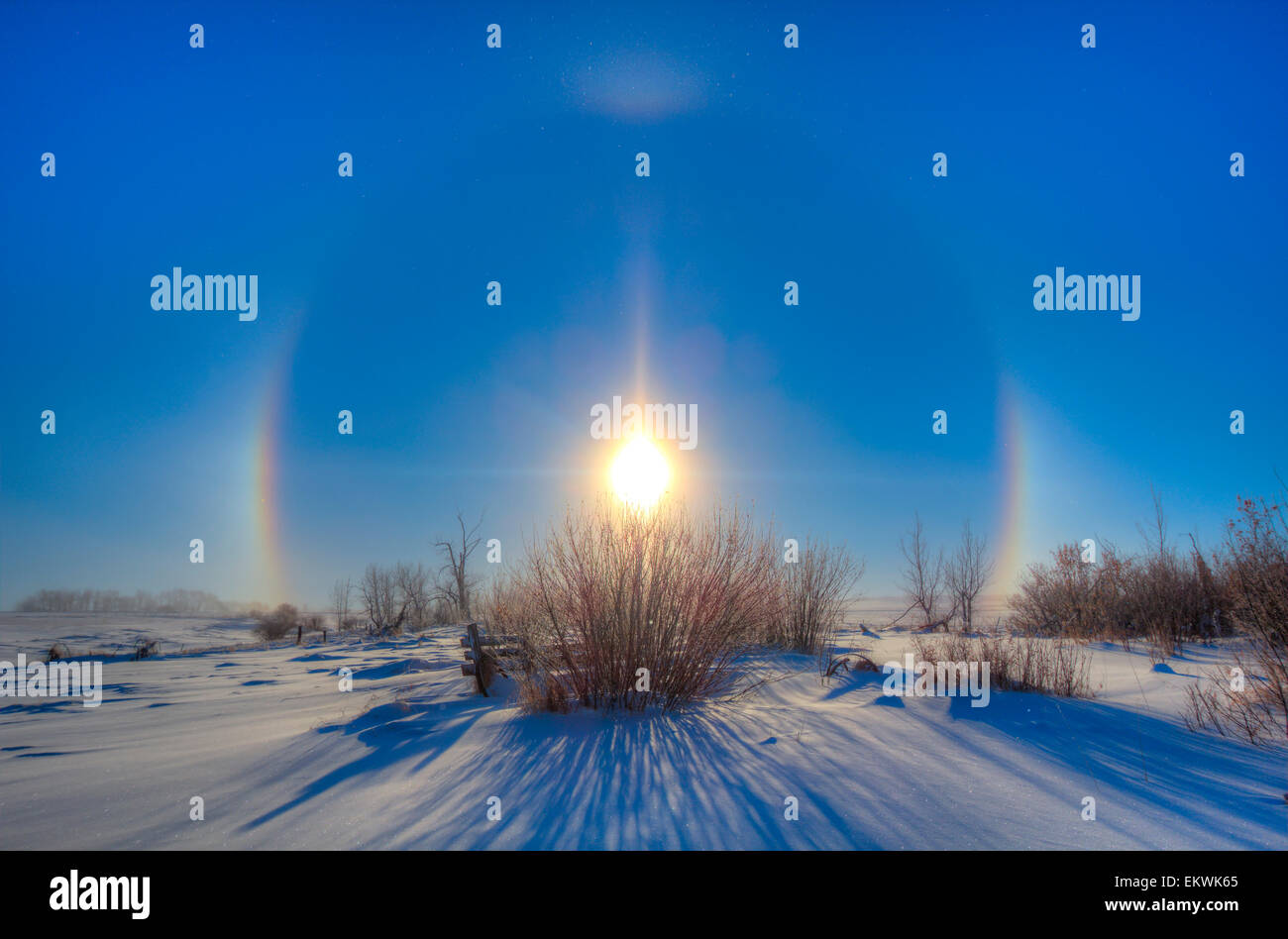 December 19, 2013 - High dynamic range photo of sundogs and a solar halo around the Sun in Alberta, Canada. The halo is caused b Stock Photo