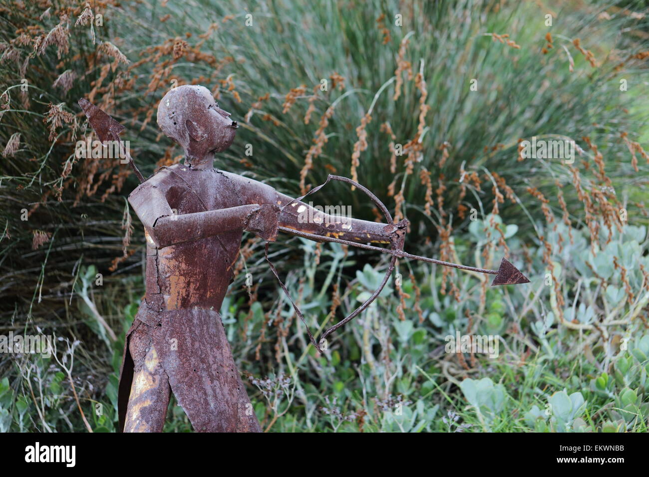 Metal sculpture of a hunter holding a bow and arrow in Harold Porter National Botanical Gardens, Betty's Bay, Stock Photo