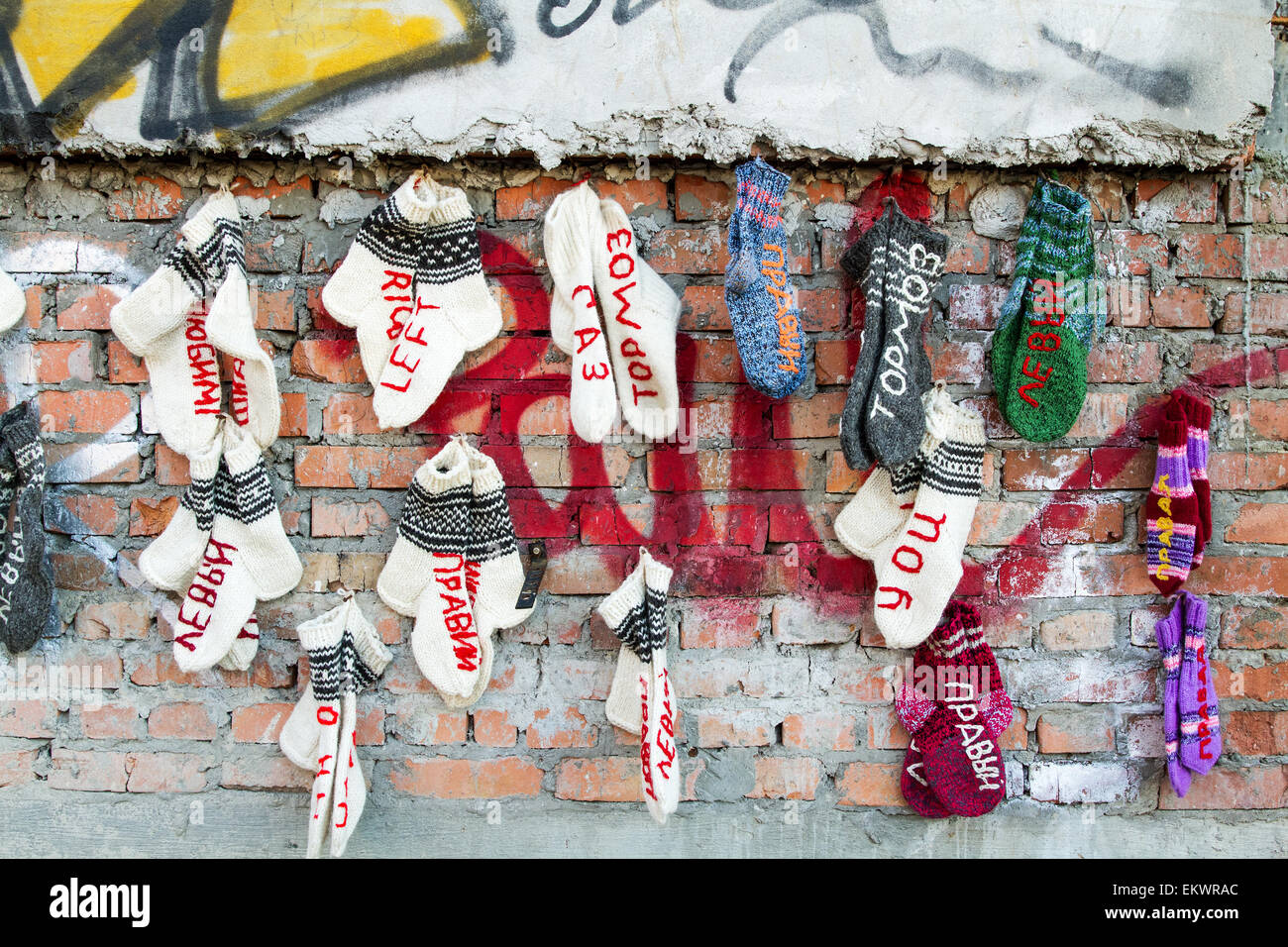 Hand knitted socks hanging on a brick wall Stock Photo Alamy