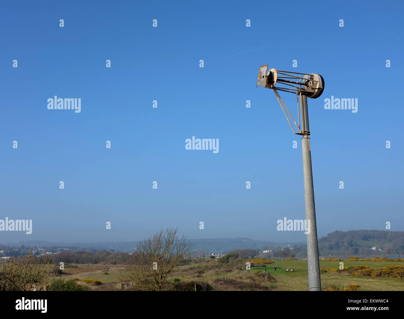 remains of a wind turbine damaged by coastal winds and weather against a blue sky Stock Photo