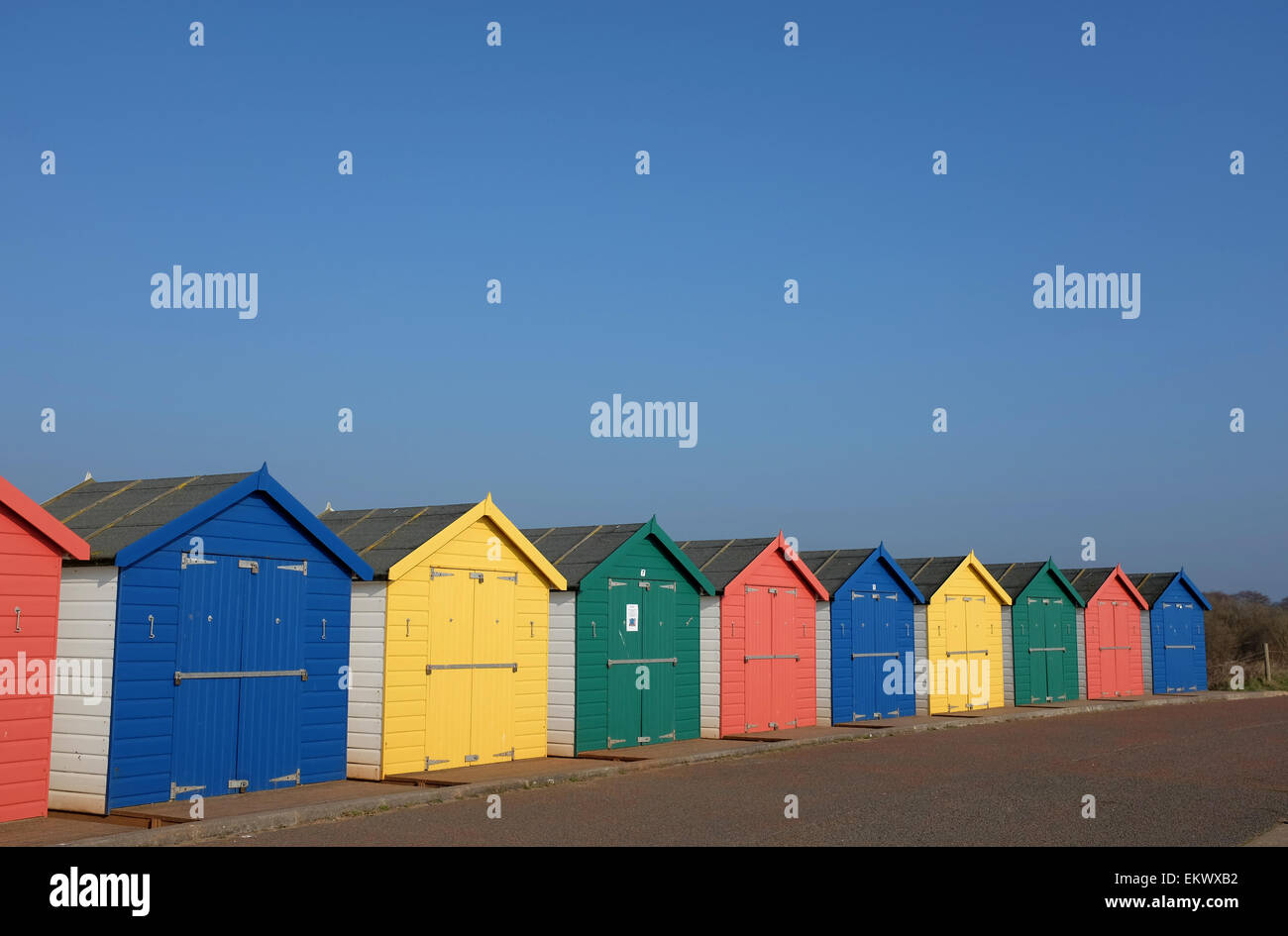bright coloured beach huts against a blue sky Dawlish Warren Devon England UK Stock Photo