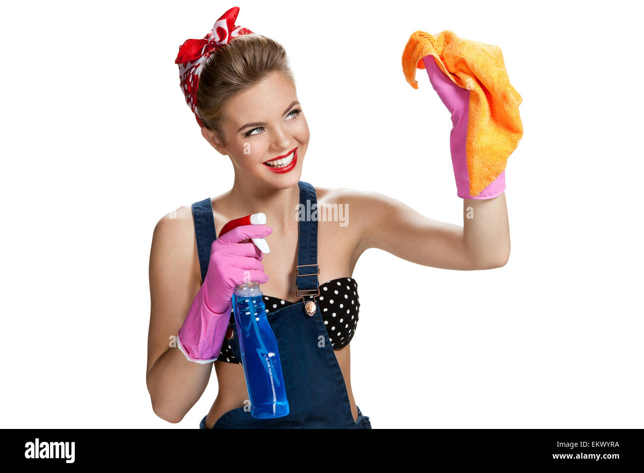 Beautiful worker wearing pink rubber protective gloves holding cleaning spray bottle and orange microfiber cloth Stock Photo