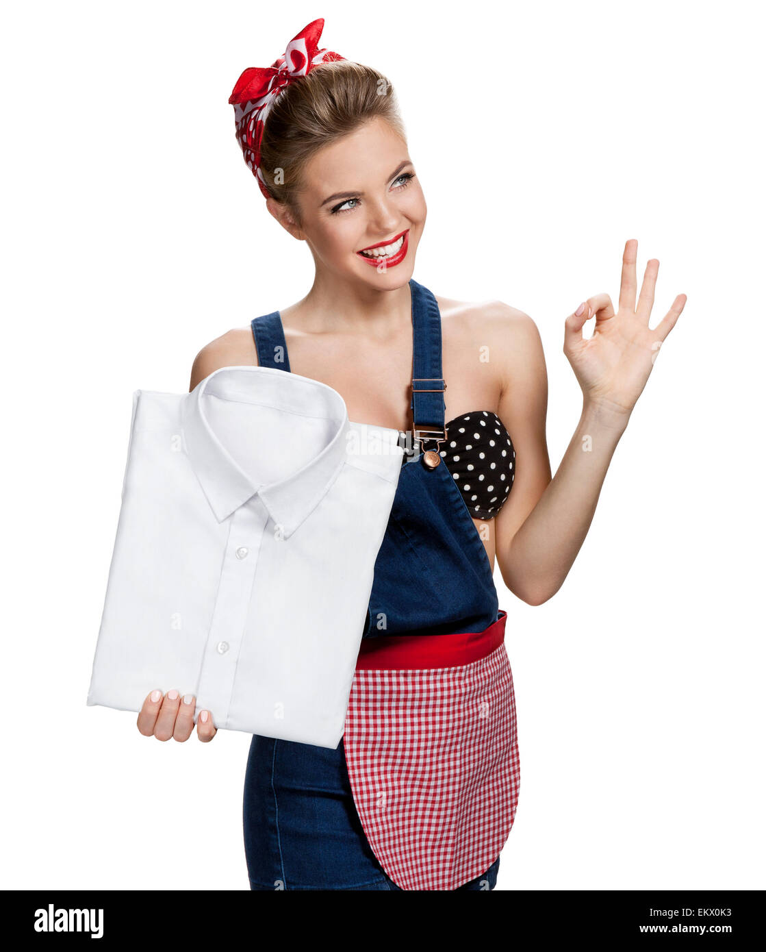 Happy housewife holding mens laundered shirt in purest white and showing us it's Okay Stock Photo