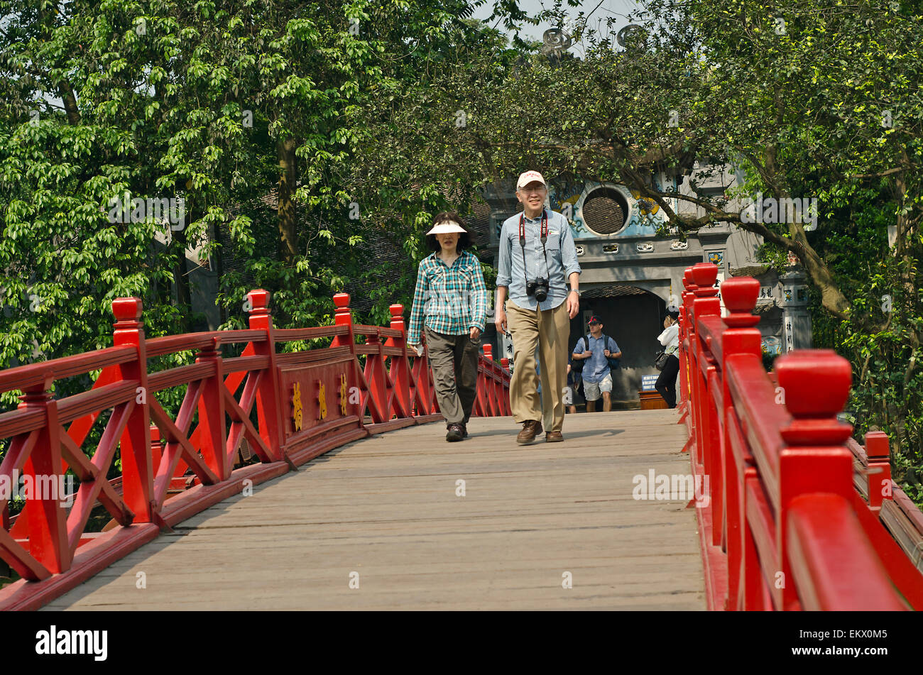 Korean tourists on the  Huc bridge leading to Ngoc Son Temple in the Hoan Kiem Lake. Hanoi, Vietnam. Stock Photo