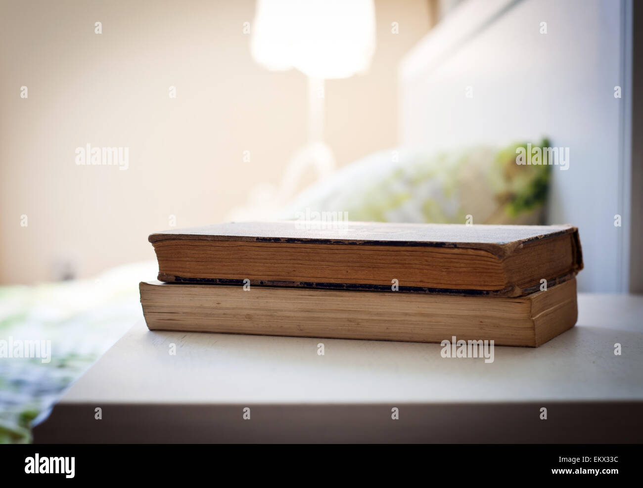 bedroom with books on nightstand Stock Photo Alamy