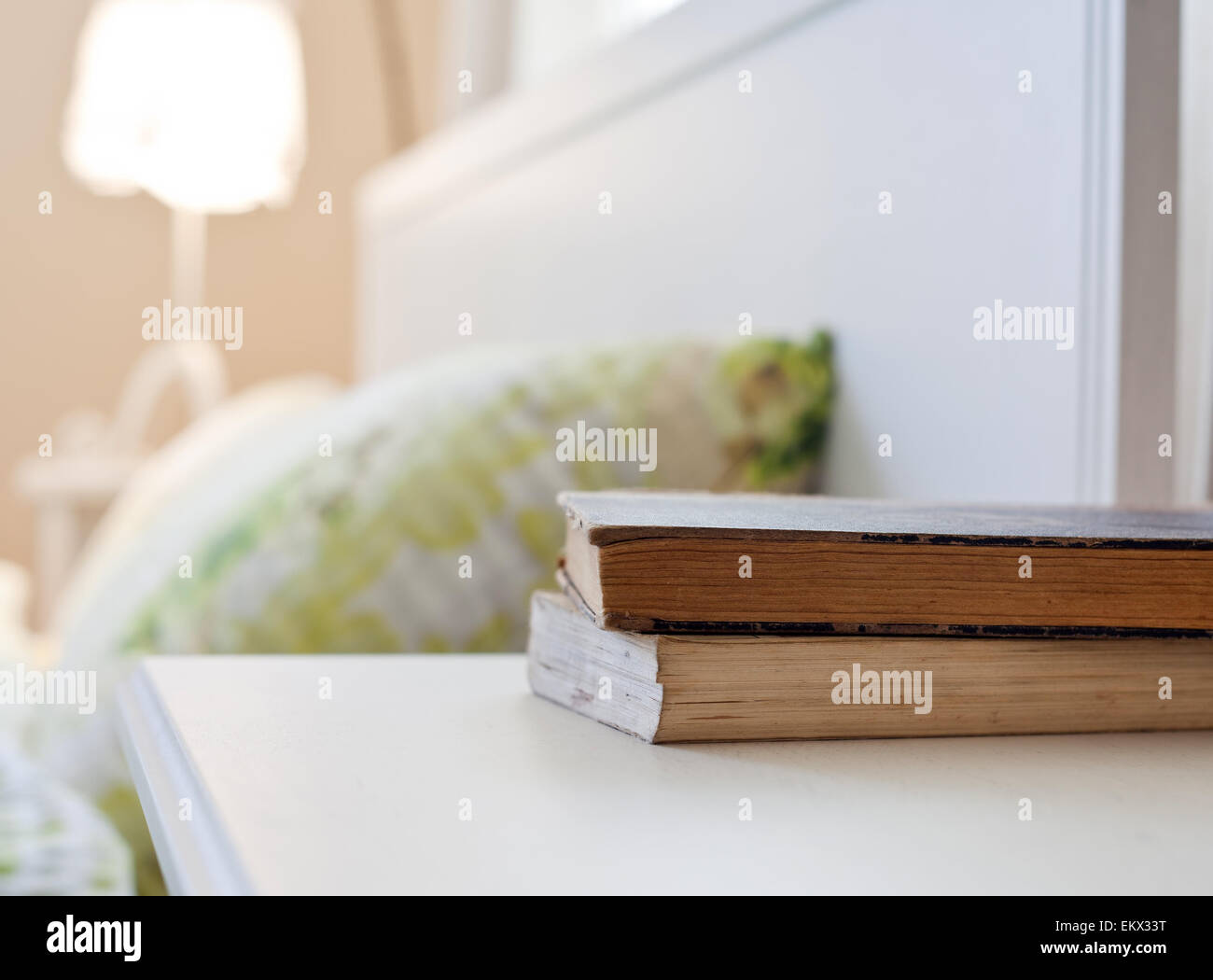 bedroom with books on nightstand Stock Photo Alamy
