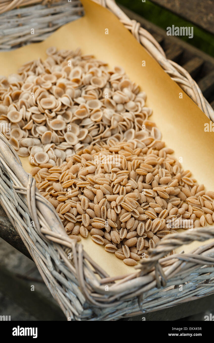 Assorted wholemeal pasta in a basket Stock Photo