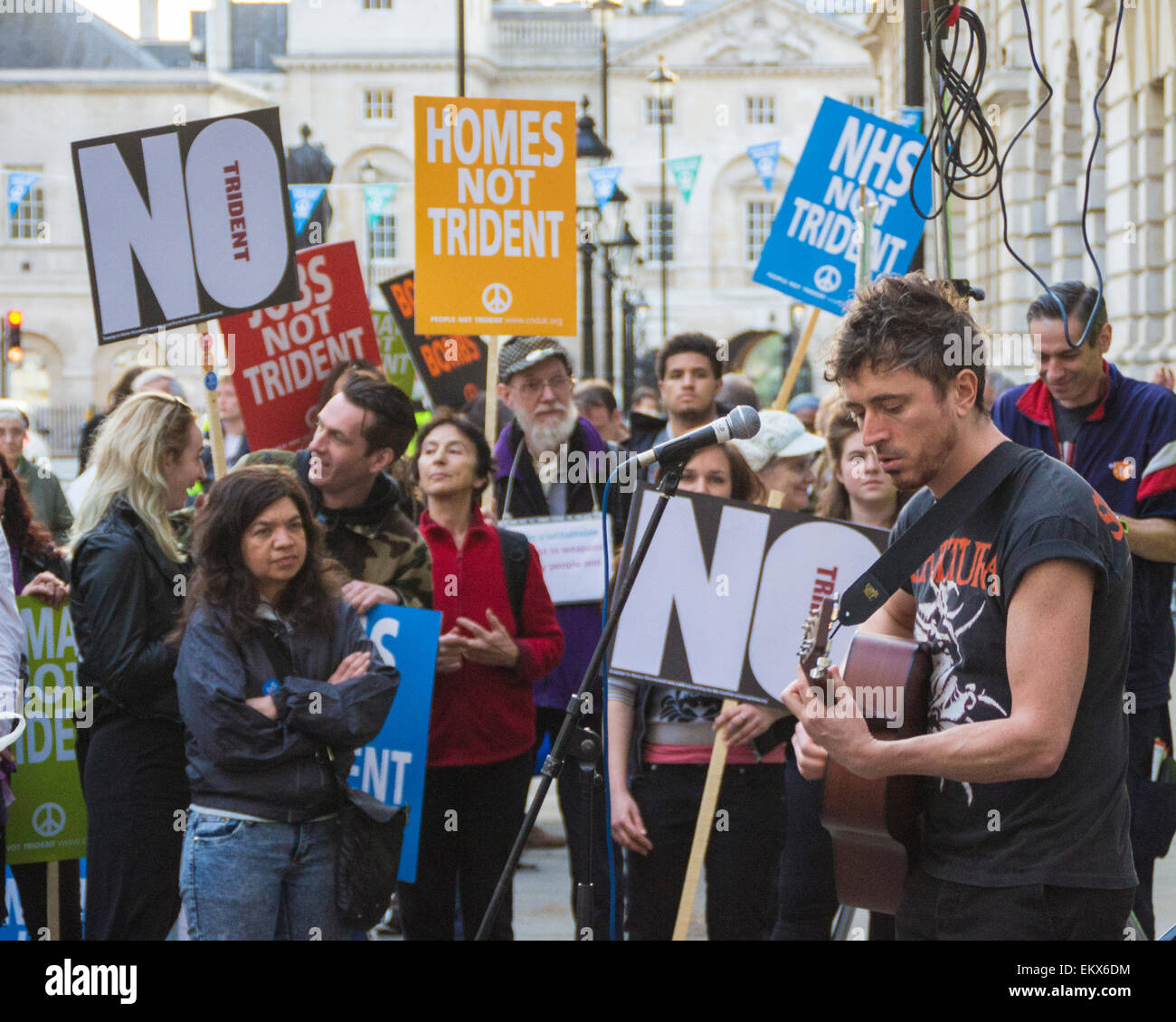 Whitehall, London, UK. 13th April, 2015. Drew McConnell performing at Vote Out Trident, an evening of Party and Protest against the renewal of Trident outside the Ministry of Defence building. Credit:  Paul Mendoza/Alamy Live News Stock Photo