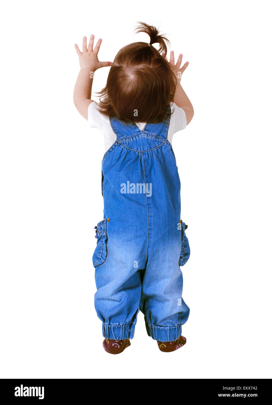 Child stands with hands up, isolated on white. Back view Stock Photo