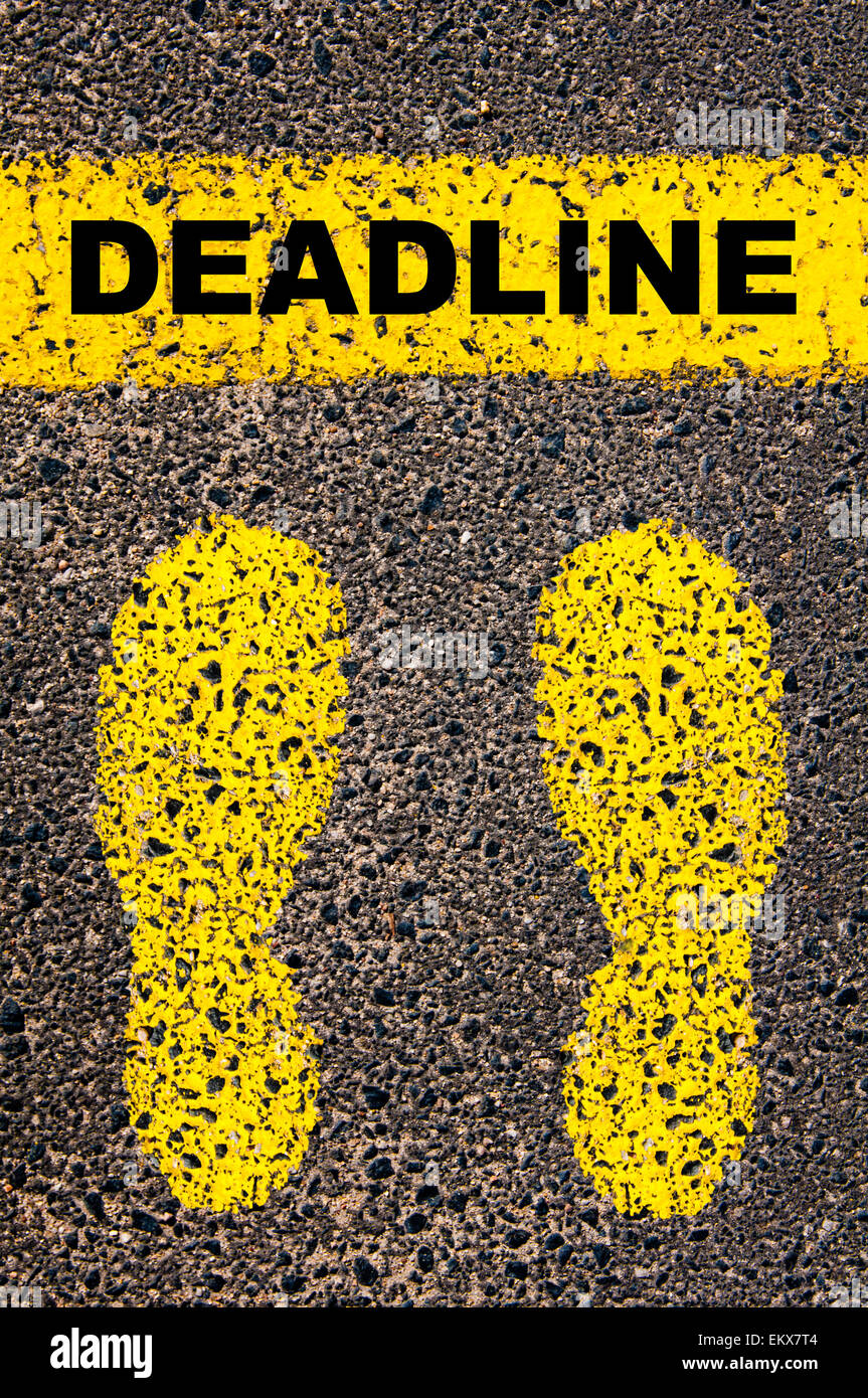 Deadline message. Conceptual image with yellow paint footsteps on the road in front of horizontal line over asphalt Stock Photo