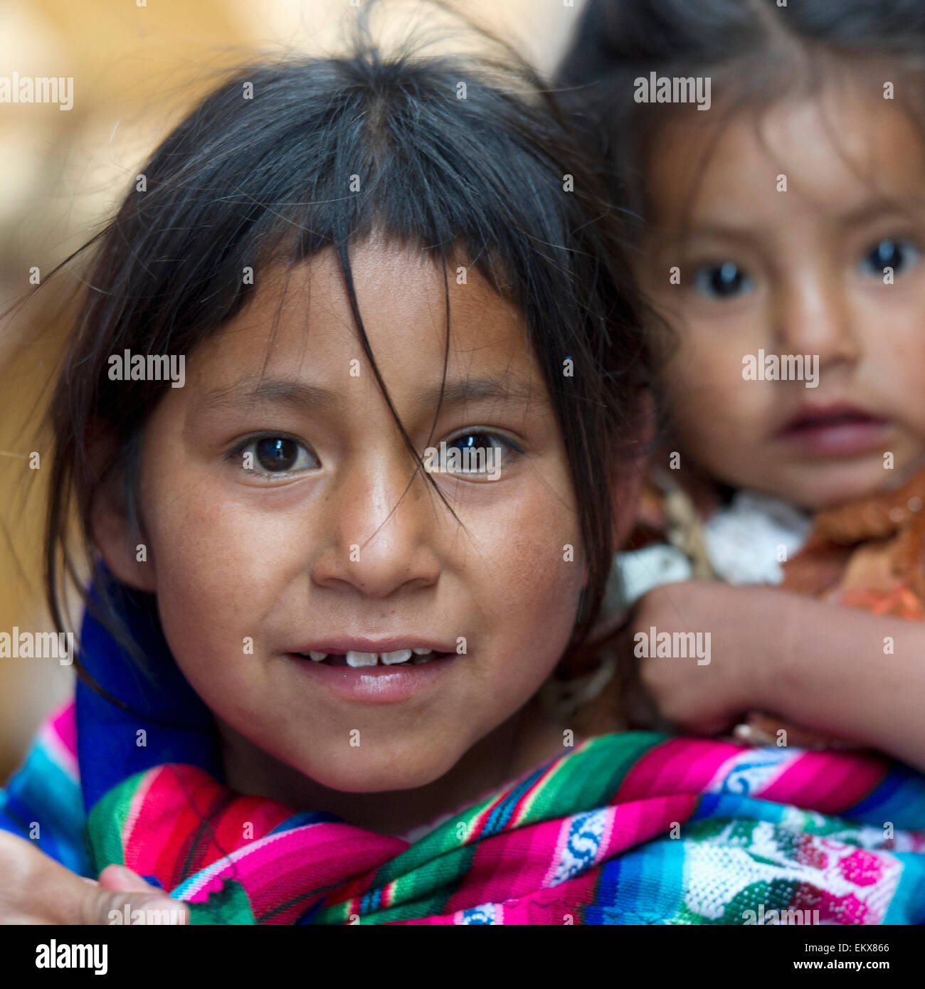 Portrait Of A Girl Carrying A Younger Girl On Her Back; Cusco Peru ...