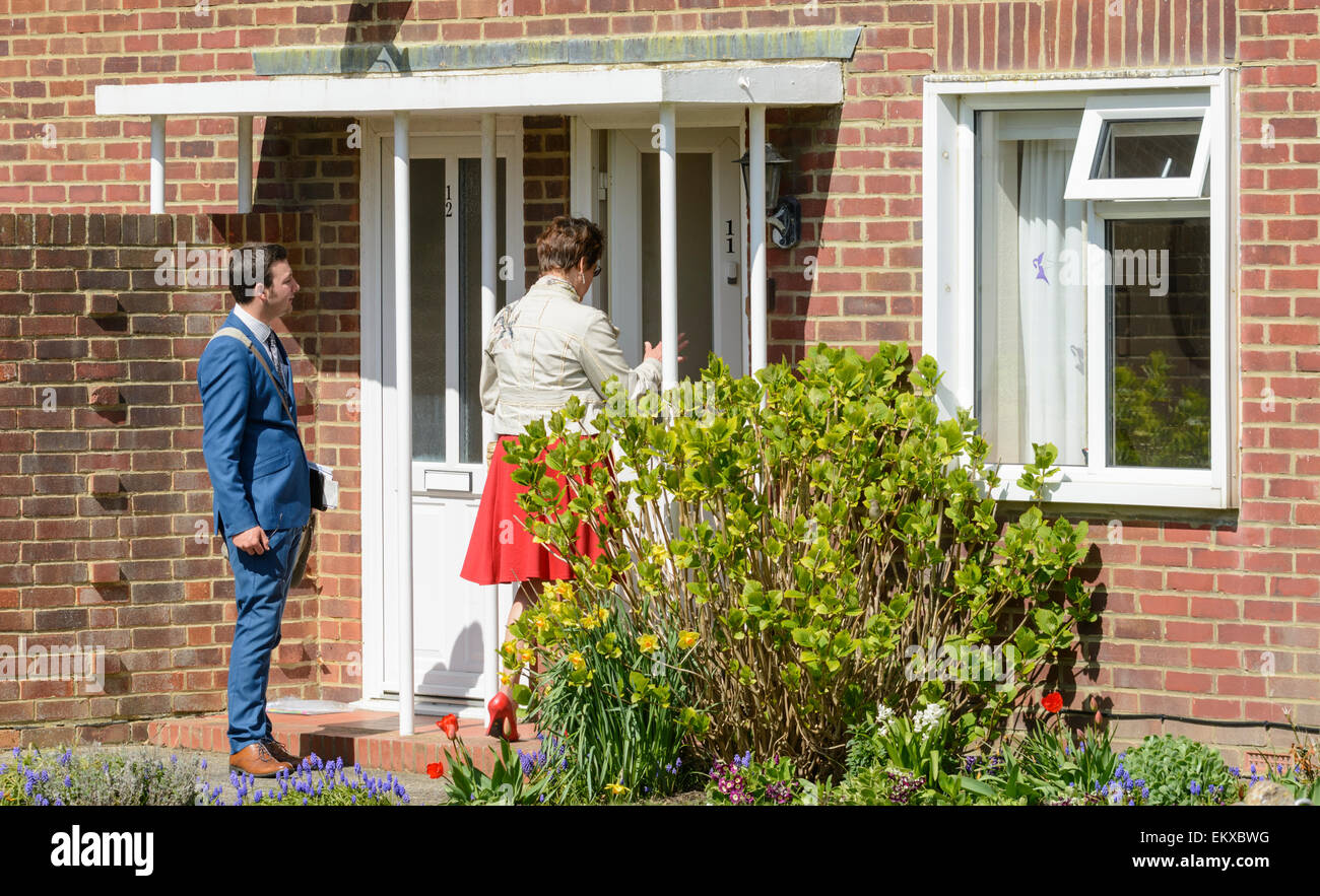 A pair of Jehovah's Witnesses knocking on doors in England, UK. Stock Photo