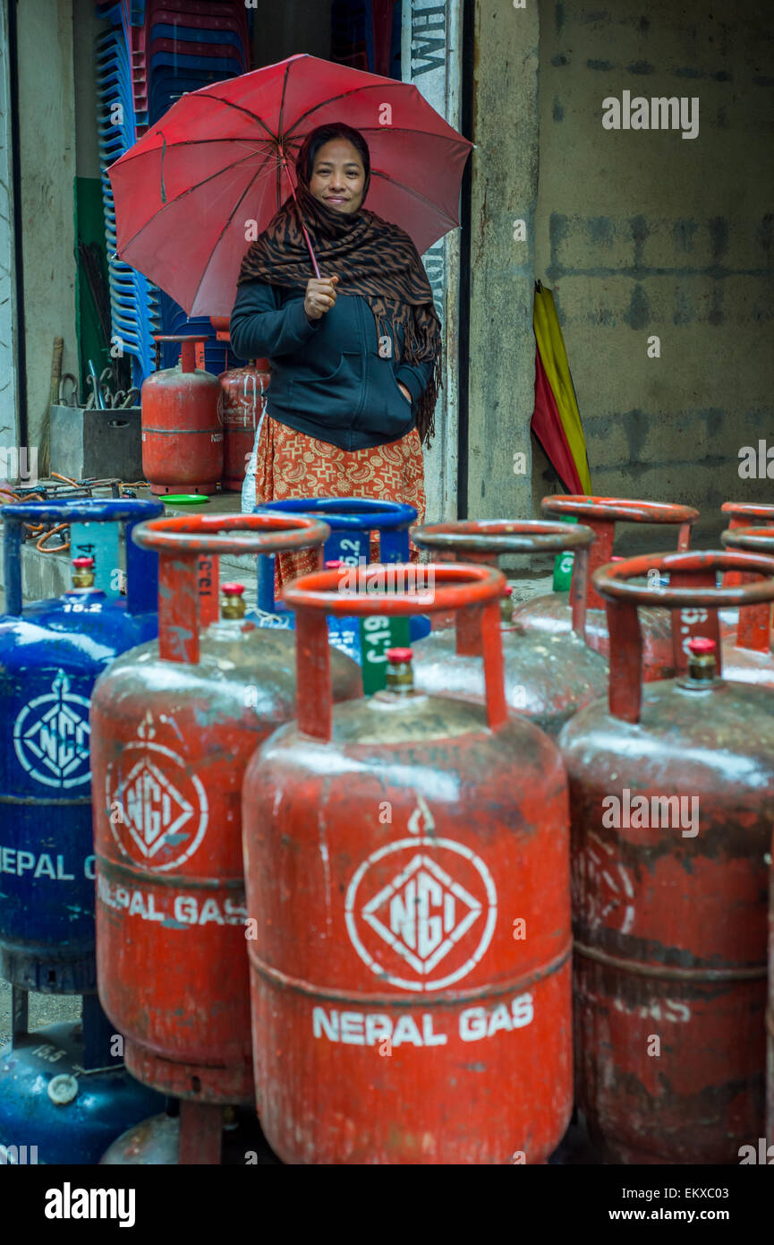 Portrait of a beautiful nepali woman, holding an umbrella, in front of